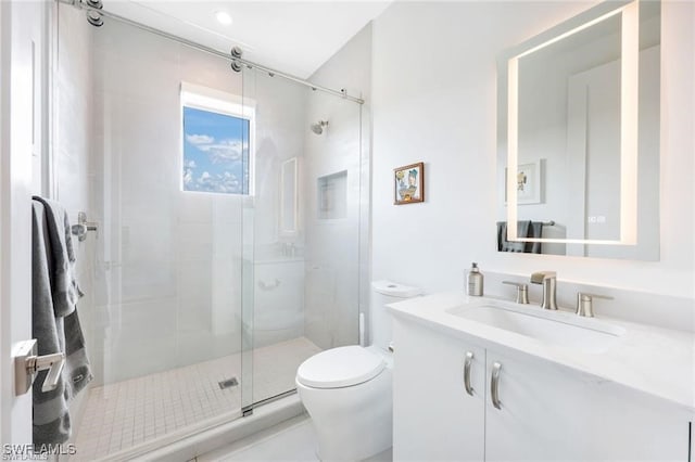 full bath featuring a stall shower, vanity, and toilet