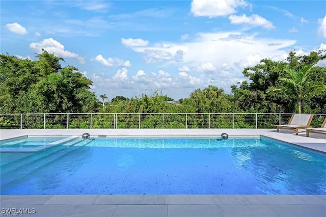 view of swimming pool featuring a pool with connected hot tub