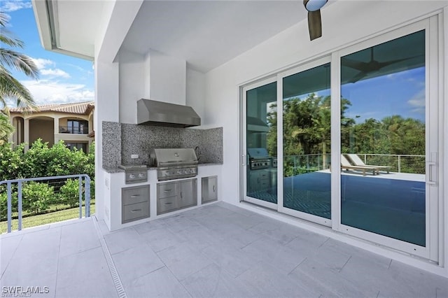 view of patio / terrace with exterior kitchen, ceiling fan, and grilling area