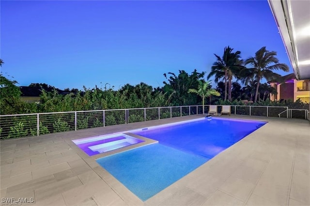 pool at dusk featuring a patio and a fenced in pool