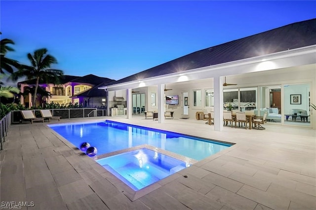 view of swimming pool featuring an in ground hot tub, a patio area, a fenced in pool, and a ceiling fan