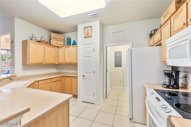 kitchen featuring light countertops, visible vents, light brown cabinetry, a sink, and white appliances