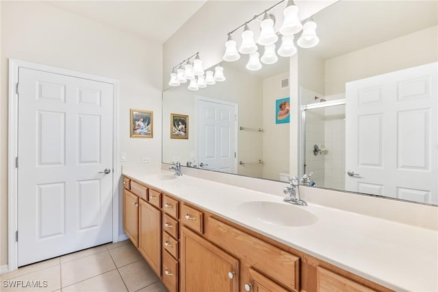 full bath with tile patterned flooring, a sink, toilet, and double vanity