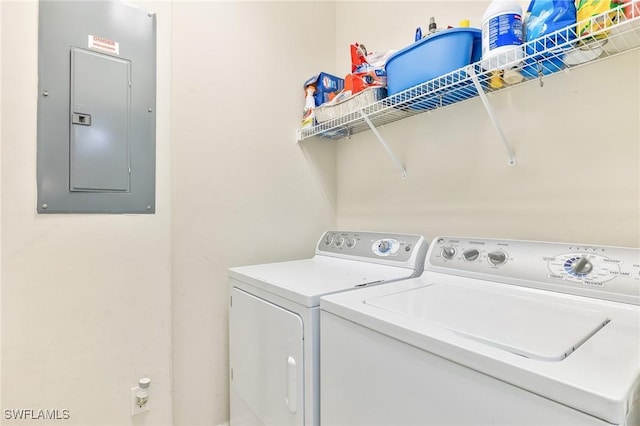 washroom featuring laundry area, electric panel, and washing machine and clothes dryer