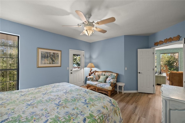 bedroom featuring ceiling fan, baseboards, and wood finished floors