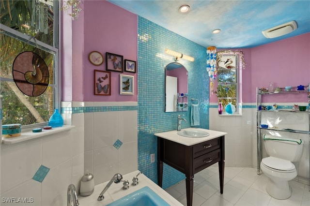 full bath with a bathtub, tile walls, visible vents, toilet, and tile patterned flooring