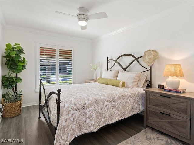 bedroom with dark wood-style floors, crown molding, and baseboards