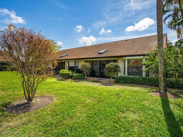 view of front of property with a front yard and stucco siding