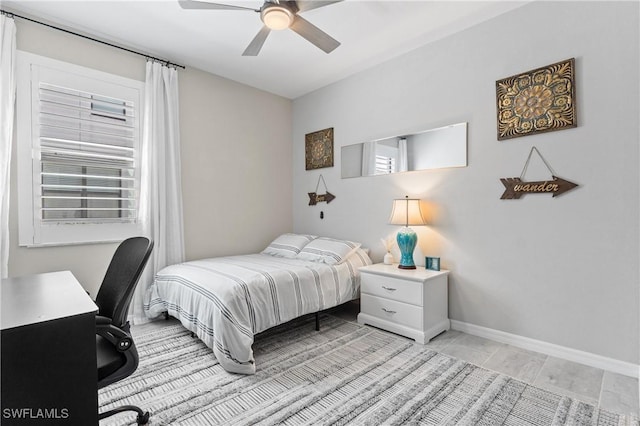 bedroom featuring baseboards and a ceiling fan