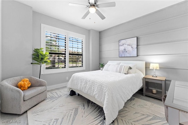 bedroom with ceiling fan and baseboards