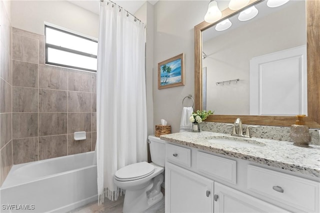 full bathroom featuring toilet, shower / bathtub combination with curtain, and vanity