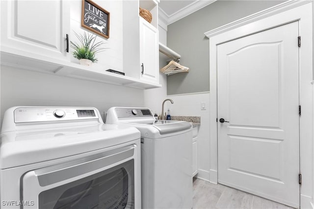 laundry area with independent washer and dryer, a sink, cabinet space, and crown molding