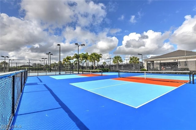 view of tennis court with fence