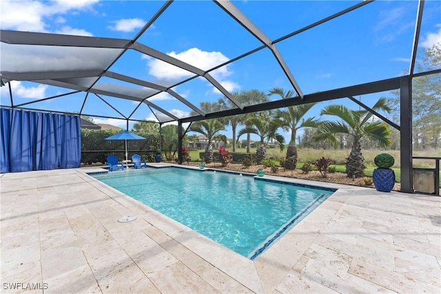 outdoor pool with glass enclosure and a patio