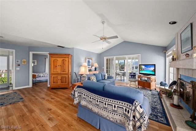 bedroom featuring lofted ceiling, light wood-type flooring, visible vents, and access to exterior