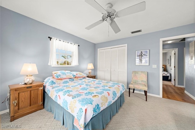 bedroom featuring light colored carpet, a closet, visible vents, and baseboards