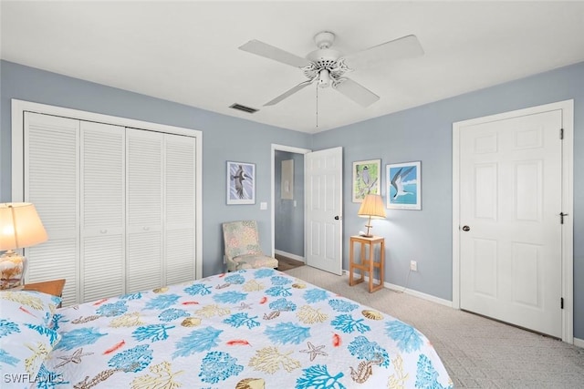 bedroom featuring carpet floors, a ceiling fan, visible vents, baseboards, and a closet