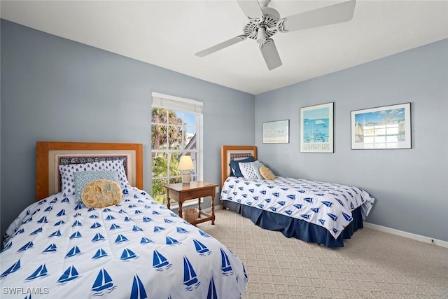 carpeted bedroom featuring ceiling fan and baseboards