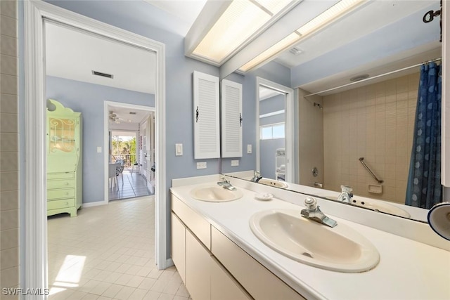 bathroom featuring visible vents, a sink, and tile patterned floors