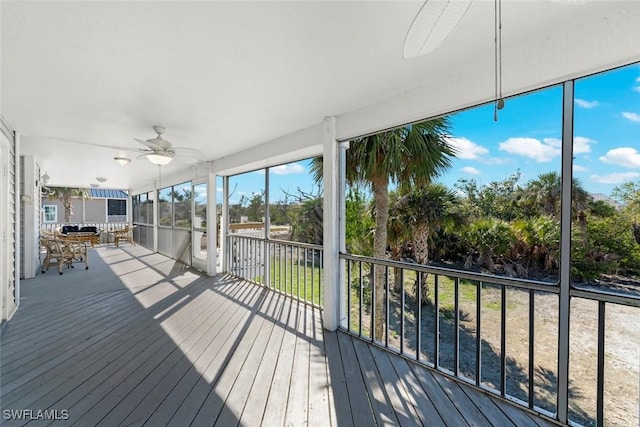 wooden deck featuring a ceiling fan