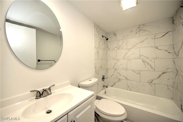 bathroom featuring washtub / shower combination, vanity, and toilet