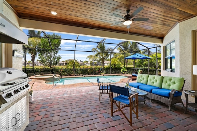 view of patio / terrace featuring area for grilling, glass enclosure, exterior kitchen, a pool with connected hot tub, and an outdoor living space