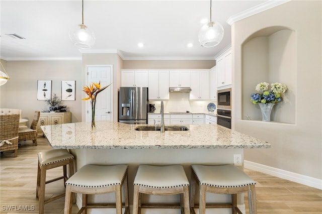 kitchen with white cabinetry, a sink, decorative light fixtures, and black appliances