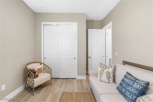 sitting room with light wood-type flooring and baseboards