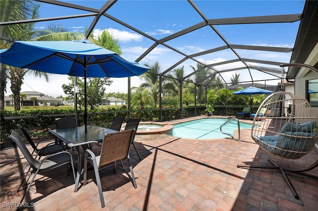 view of swimming pool featuring glass enclosure, a pool with connected hot tub, and a patio