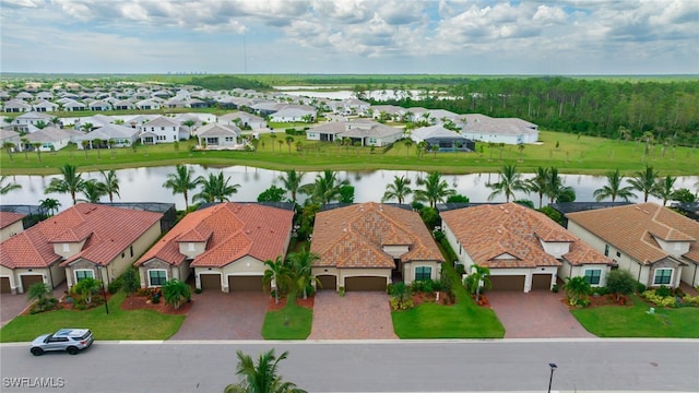 drone / aerial view featuring a residential view and a water view