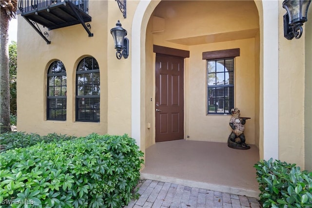 doorway to property with stucco siding