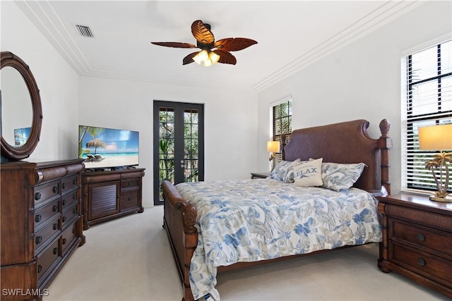 bedroom with french doors, crown molding, visible vents, a ceiling fan, and light carpet