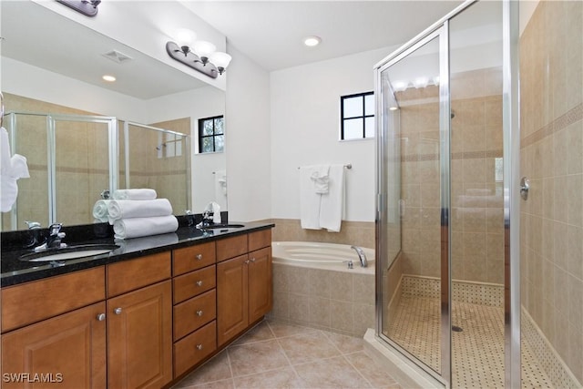 bathroom with a stall shower, visible vents, and a sink