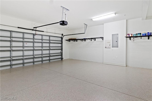 garage featuring electric panel and a garage door opener