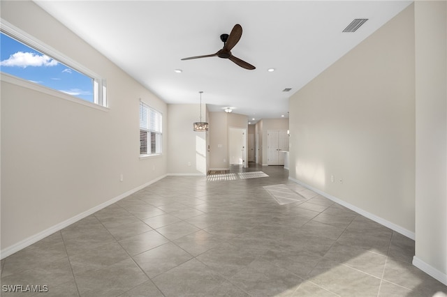 unfurnished living room with ceiling fan, light tile patterned floors, recessed lighting, visible vents, and baseboards