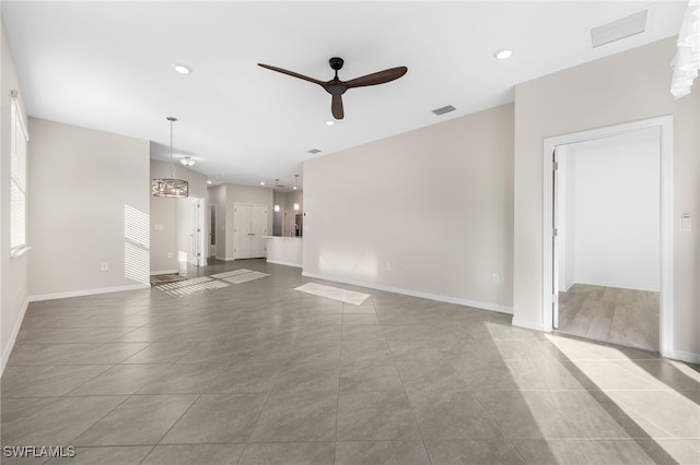 unfurnished living room featuring ceiling fan, visible vents, baseboards, and recessed lighting