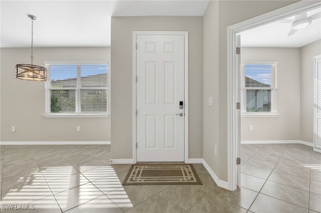 foyer with light tile patterned floors and baseboards