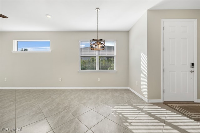 interior space with baseboards and light tile patterned floors