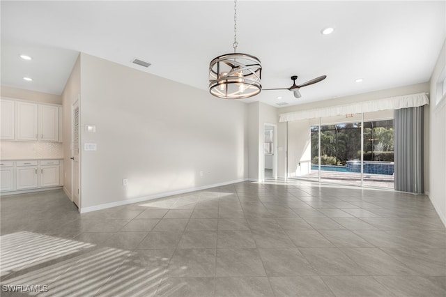 unfurnished room with recessed lighting, visible vents, light tile patterned flooring, baseboards, and ceiling fan with notable chandelier