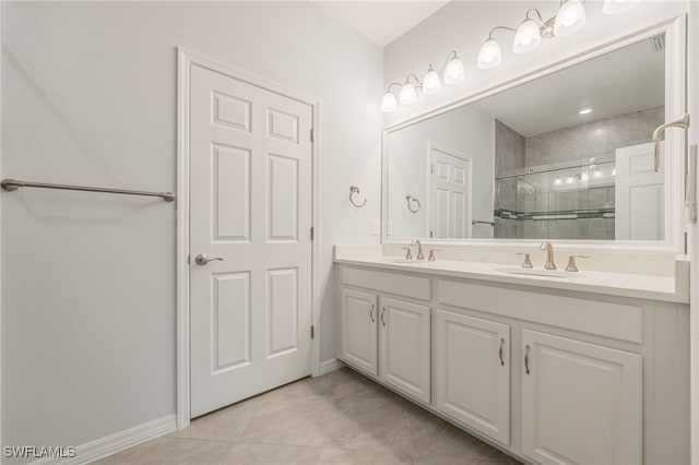 full bath with double vanity, a shower stall, a sink, and tile patterned floors