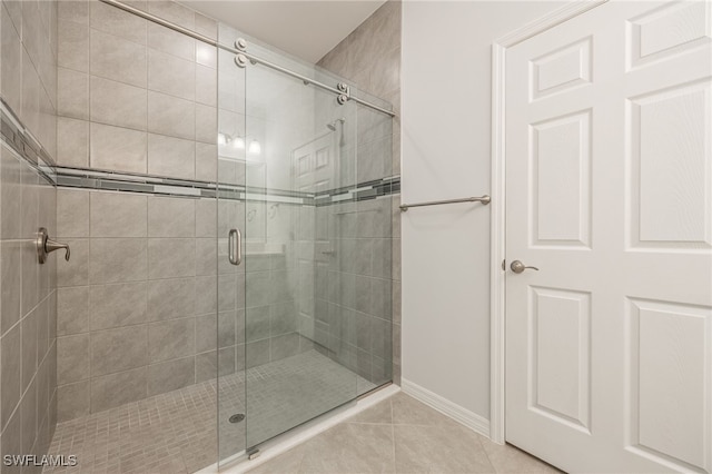 full bathroom featuring a shower stall and tile patterned floors