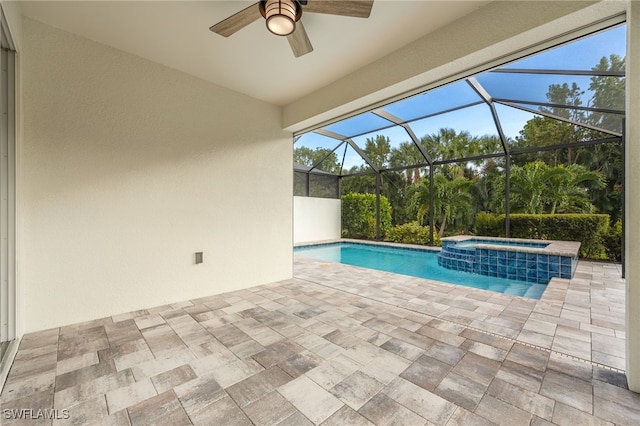 view of pool featuring a lanai, a patio area, and a pool with connected hot tub