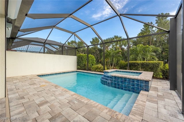 view of swimming pool with glass enclosure, a pool with connected hot tub, and a patio