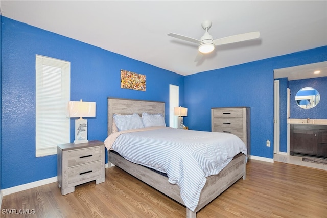 bedroom with ceiling fan, baseboards, and wood finished floors