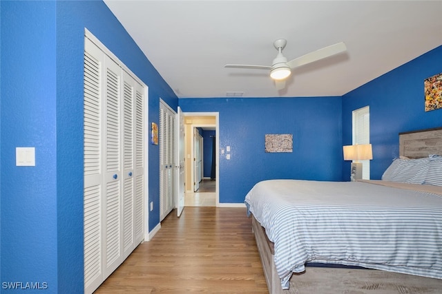 bedroom featuring a closet, wood finished floors, a ceiling fan, and baseboards