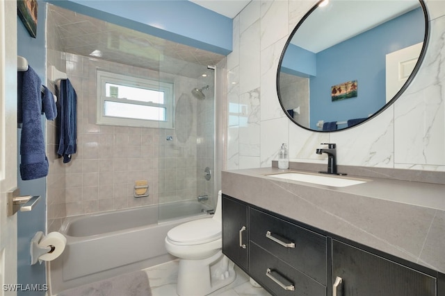 bathroom with tasteful backsplash, toilet, marble finish floor, vanity, and shower / bathing tub combination