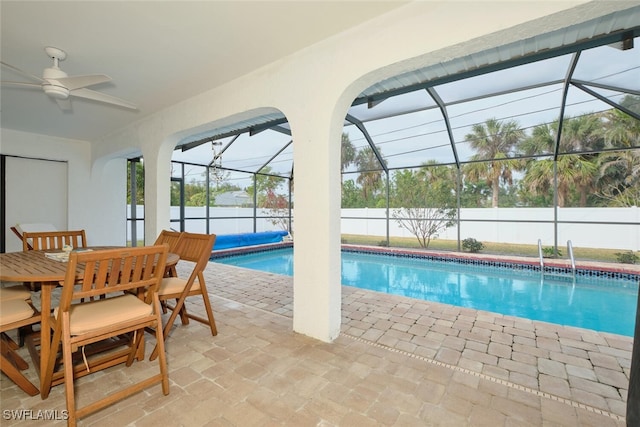 view of pool featuring a fenced in pool, glass enclosure, a patio, and ceiling fan