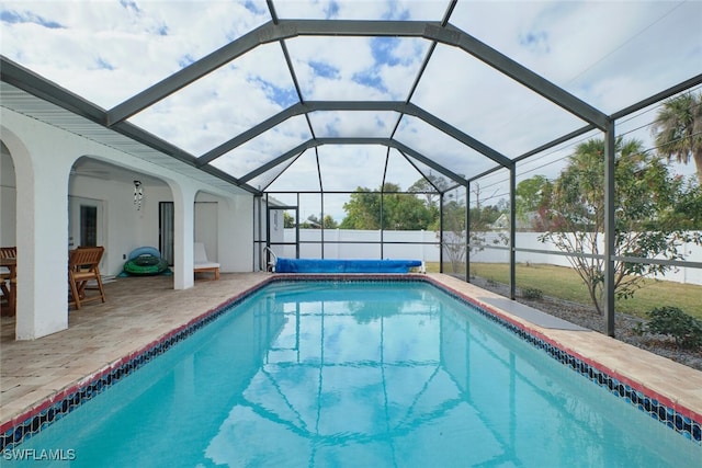 view of swimming pool featuring glass enclosure, a patio area, a fenced backyard, and a fenced in pool