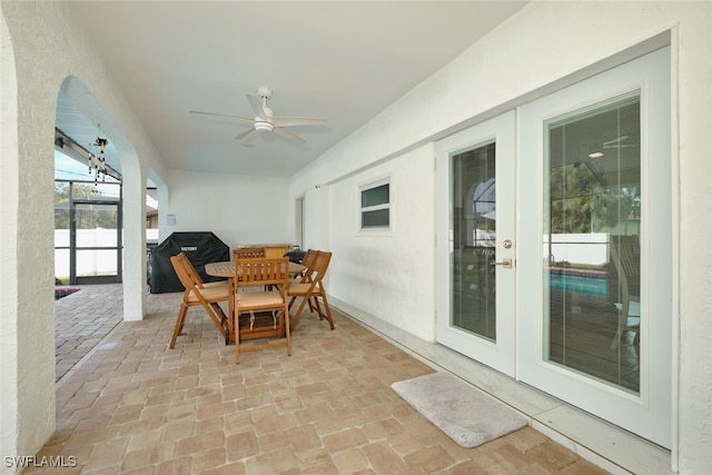 sunroom / solarium with a ceiling fan