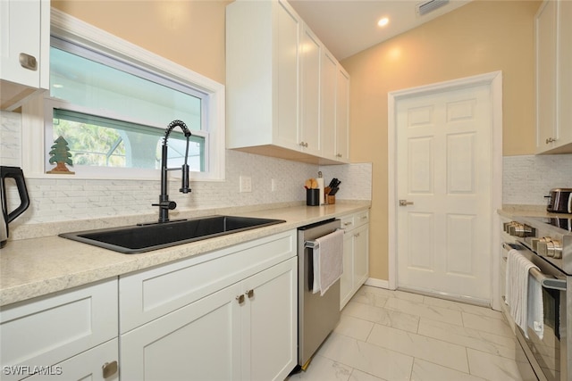 kitchen with marble finish floor, visible vents, appliances with stainless steel finishes, white cabinets, and a sink